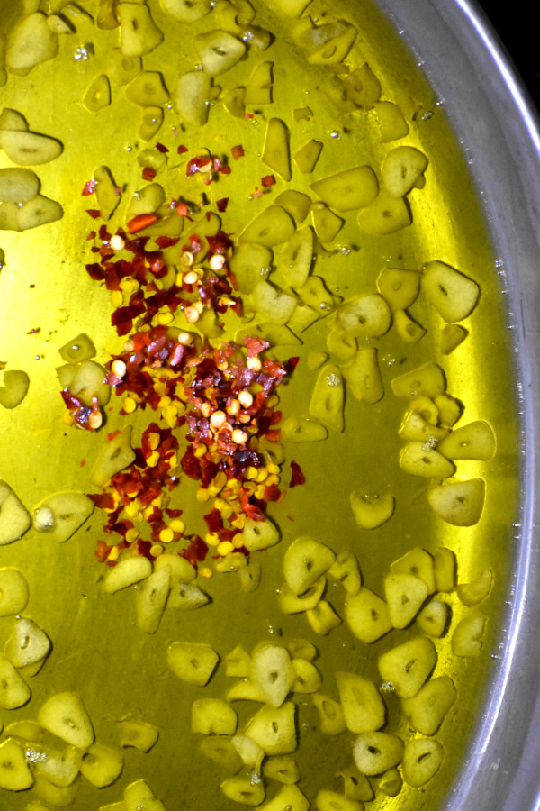 把红辣椒片加入蒜油混合物中。